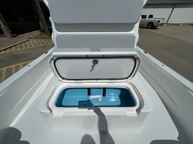 Slide: The Image of 2024 Shallow Sport 24 Modified V boat with open storage compartment. - 18