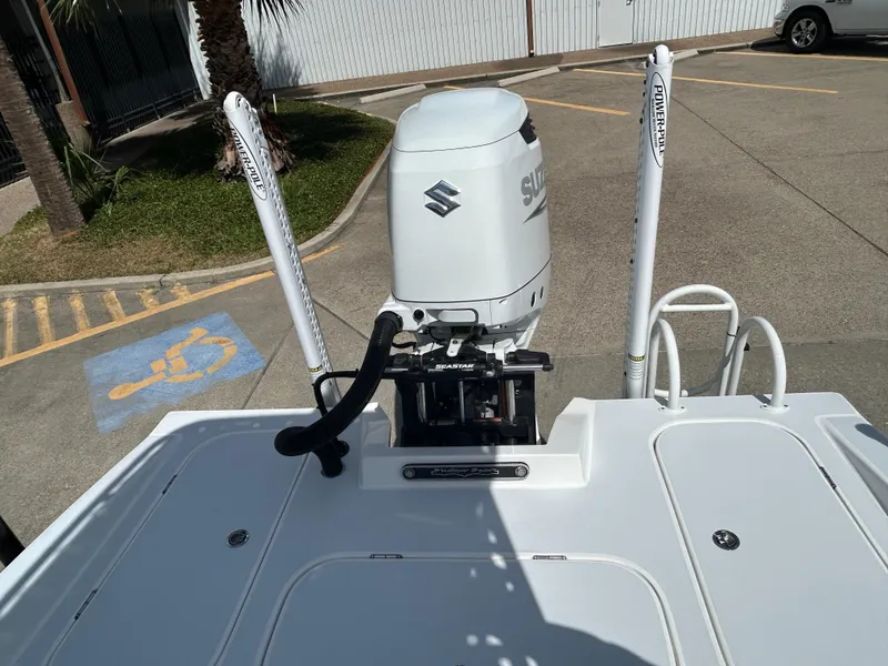 Slide: The Image of 2024 Shallow Sport 24 Modified V boat with Suzuki outboard motor in parking lot. - 7