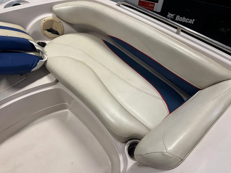 Slide: The Image of 2015 Tahoe 215 Xi boat interior with white and blue seating. - 14