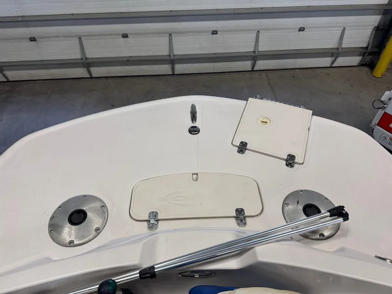 Slide: The Image of 2015 Tahoe 215 Xi boat deck with storage compartments and metal fixtures. - 16