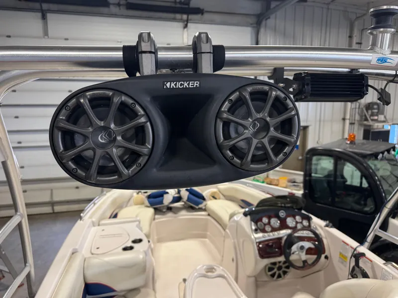 Slide: The Image of Kicker speakers on 2015 Tahoe 215 Xi boat, interior view with dashboard and seating. - 8