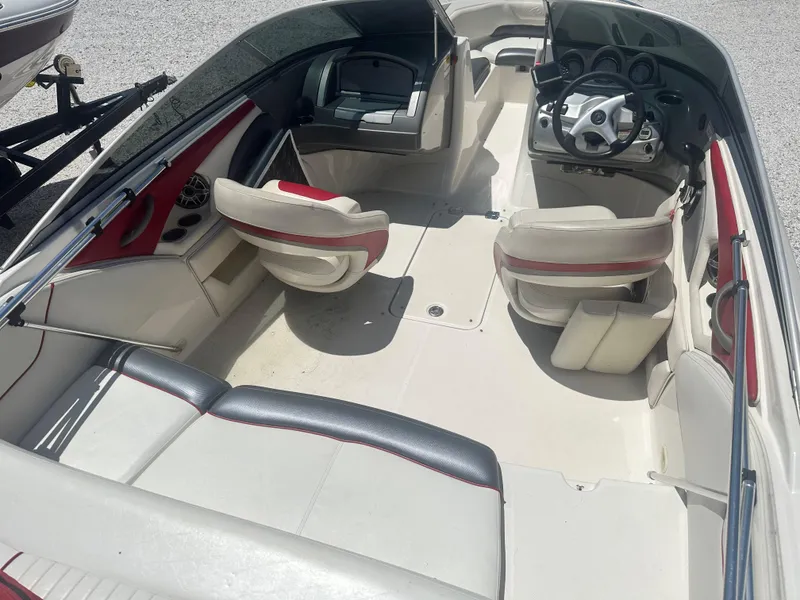 Slide: The Image of 2006 Monterey 194 FS boat interior with seating and steering wheel, viewed from above. - 5