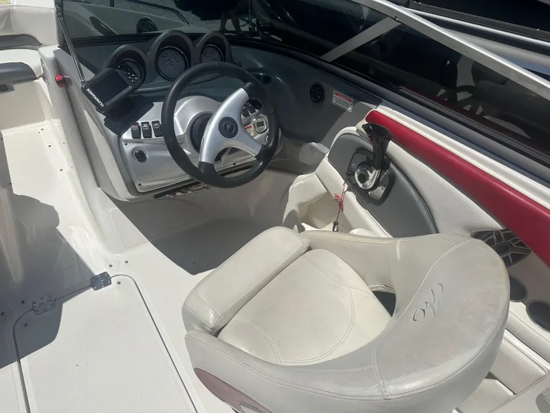 Slide: The Image of 2006 Monterey 194 FS boat interior with steering wheel and dashboard controls. - 7
