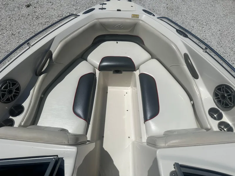 Slide: The Image of 2006 Monterey 194 FS boat interior with cushioned seating and speaker system. - 8