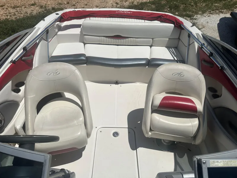 Slide: The Image of 2006 Monterey 194 FS boat interior with white and red seating. - 9
