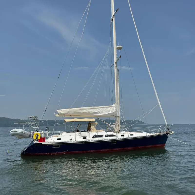 The Image of Sailboat Hylas 46, 1998 model, anchored on calm water under a clear blue sky. - 0