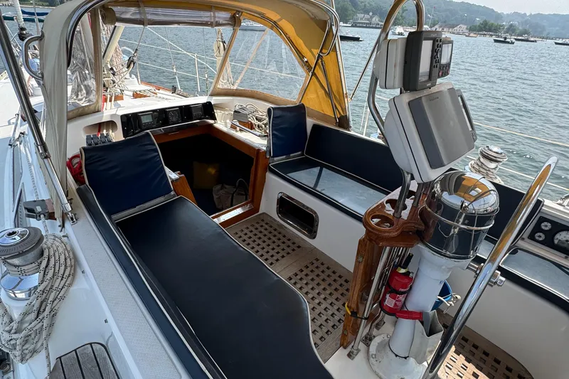 Slide: The Image of Cockpit of a 1998 Hylas 46 sailboat with navigation equipment and seating. - 26