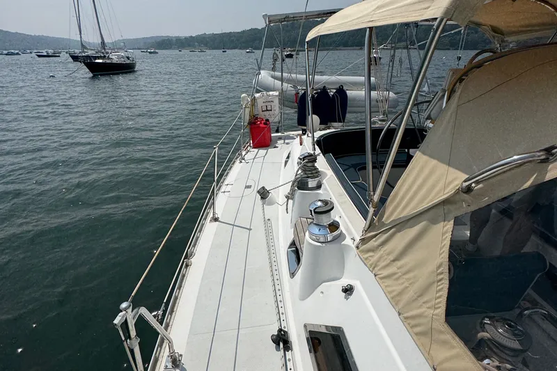 Slide: The Image of Sailing yacht Hylas 46, 1998 model, docked on calm waters with scenic background. - 27