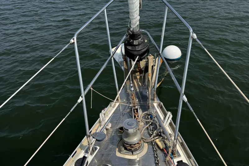Slide: The Image of Bow of 1998 Hylas 46 sailboat with winch and ropes on calm water. - 28