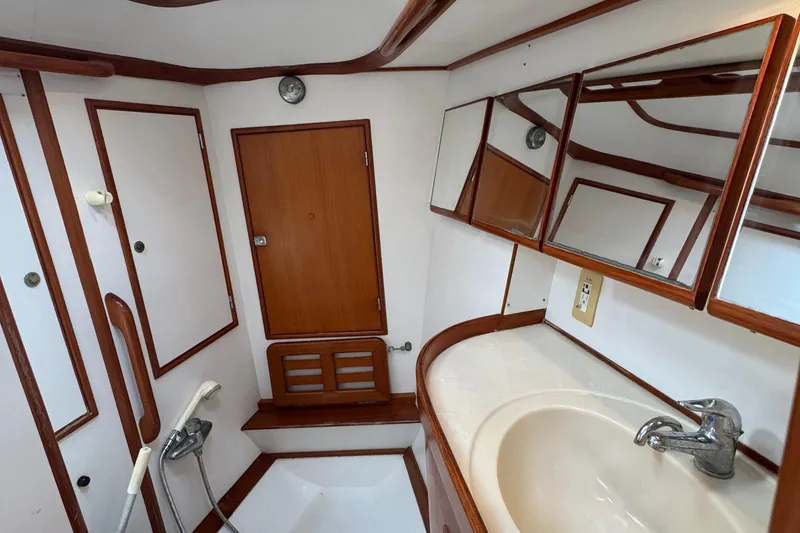 Slide: The Image of Bathroom interior of a 1998 Hylas 46 yacht with wooden accents and mirrors. - 29