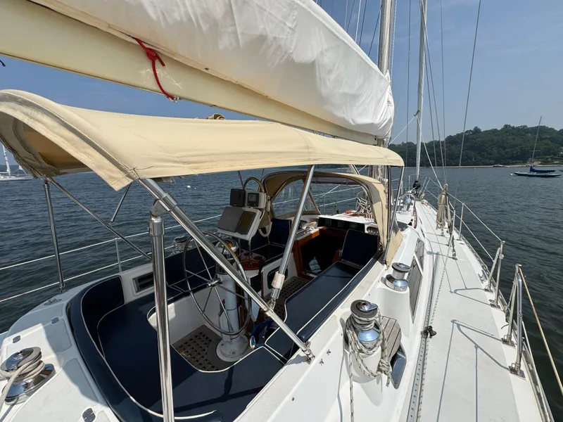 Slide: The Image of Sailing yacht Hylas 46, 1998 model, with spacious cockpit and canopy on calm waters. - 4