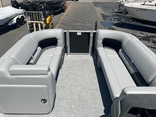 Slide: The Image of 2026 Sun Tracker Party Barge 20 DLX with spacious seating in a marina setting. - 12