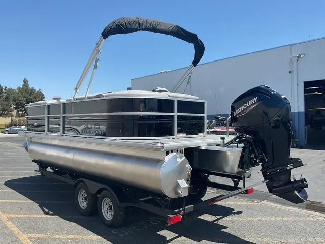 Slide: The Image of 2026 Sun Tracker Party Barge 20 DLX pontoon boat with Mercury engine on trailer. - 17