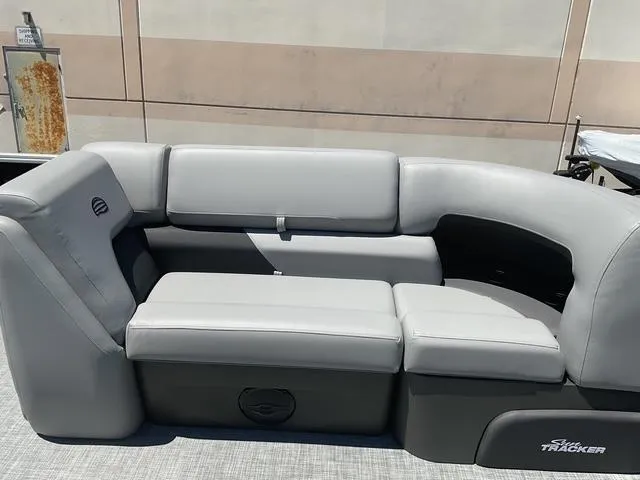 Slide: The Image of 2026 Sun Tracker Party Barge 20 DLX pontoon boat seating, featuring gray cushioned seats. - 8