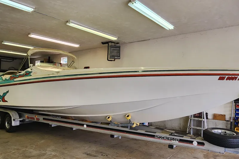 Slide: The Image of 1995 Cigarette 38 Signature Edition boat on trailer in a garage. - 1