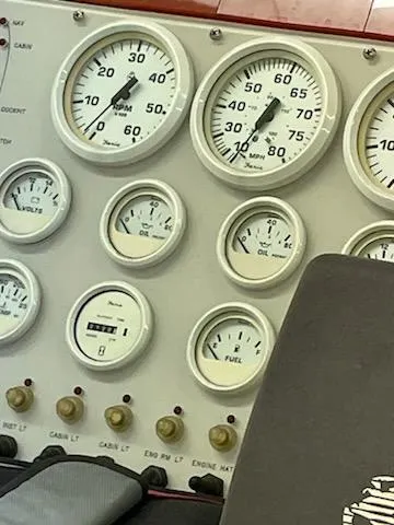 Slide: The Image of Dashboard of a 1995 Cigarette 38 Signature Edition boat with various gauges and controls. - 10