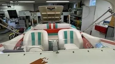 Slide: The Image of 1995 Cigarette 38 Signature Edition boat interior with colorful seating in a garage. - 12