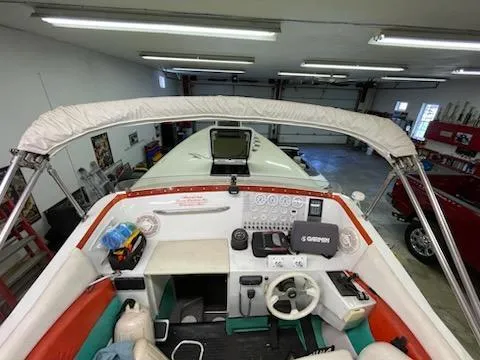Slide: The Image of 1995 Cigarette 38 Signature Edition boat interior with steering wheel and control panel in a garage. - 13