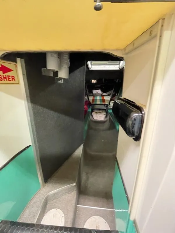 Slide: The Image of Interior view of a 1995 Cigarette 38 Signature Edition boat, featuring a narrow passageway. - 15