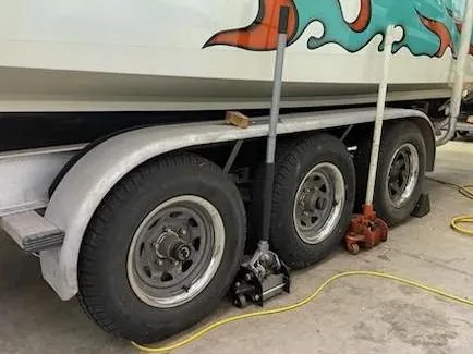 Slide: The Image of Trailer with triple axles supporting a 1995 Cigarette 38 Signature Edition boat. - 18