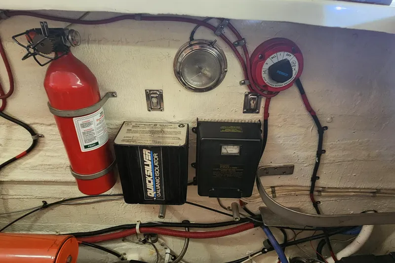 Slide: The Image of Engine room of 1995 Cigarette 38 Signature Edition with fire extinguisher and electrical components. - 24