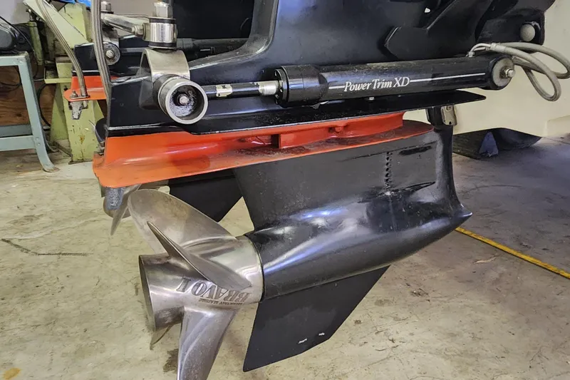 Slide: The Image of 1995 Cigarette 38 Signature Edition boat propeller and Power Trim XD system in a workshop. - 27