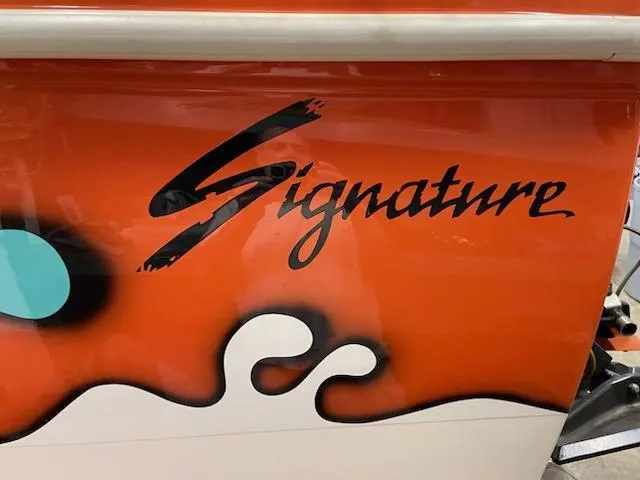 Slide: The Image of 1995 Cigarette 38 Signature Edition boat with vibrant orange and black design. - 8