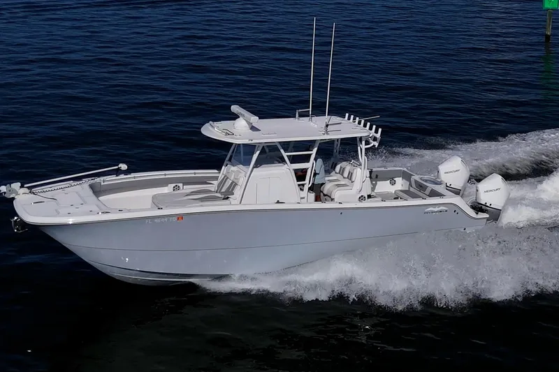 Slide: The Image of 2022 Invincible 33 Catamaran cruising on open water with twin outboard engines. - 0