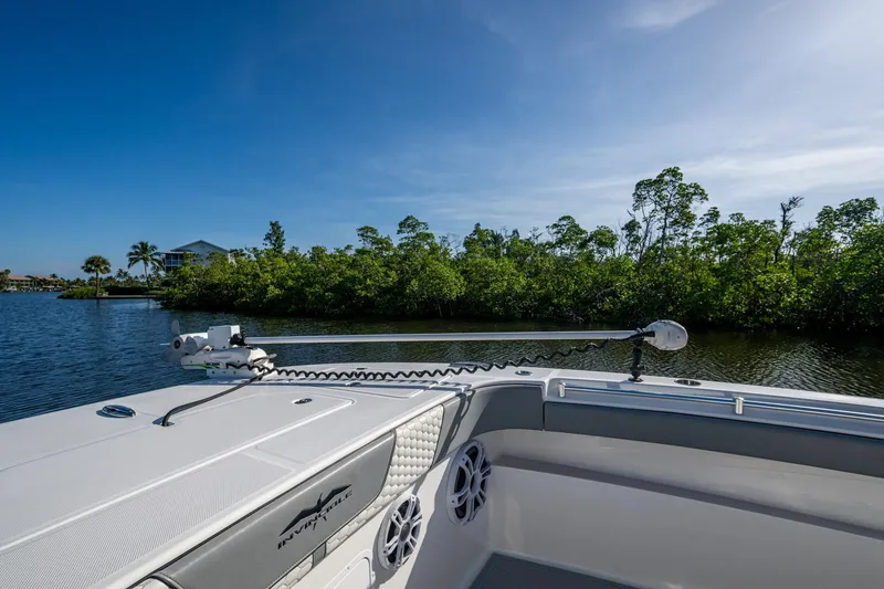 Slide: The Image of 2022 Invincible 33 Catamaran on calm water, lush greenery in the background. - 11