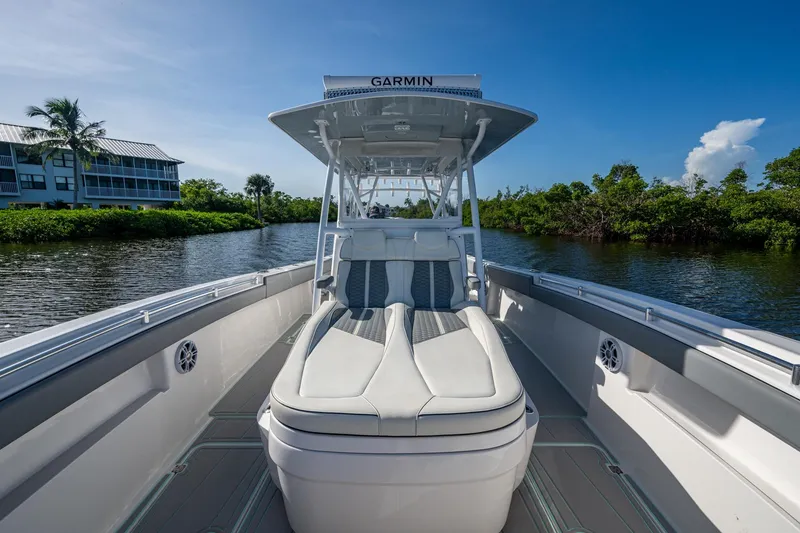 Slide: The Image of 2022 Invincible 33 Catamaran on calm water, featuring sleek seating and modern design. - 15