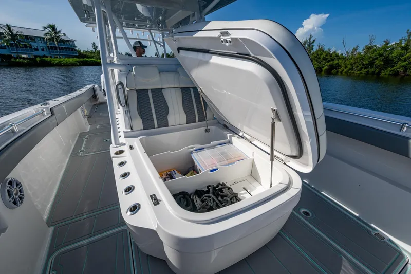 Slide: The Image of 2022 Invincible 33 Catamaran with open storage compartment on deck, near waterway. - 17