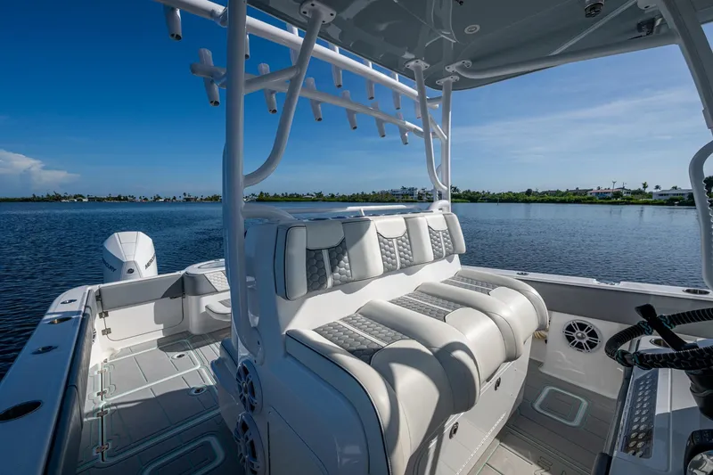 Slide: The Image of 2022 Invincible 33 Catamaran interior with luxurious seating on calm water. - 18