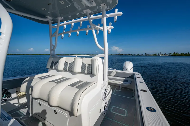 Slide: The Image of 2022 Invincible 33 Catamaran on calm water, featuring sleek seating and modern design. - 19