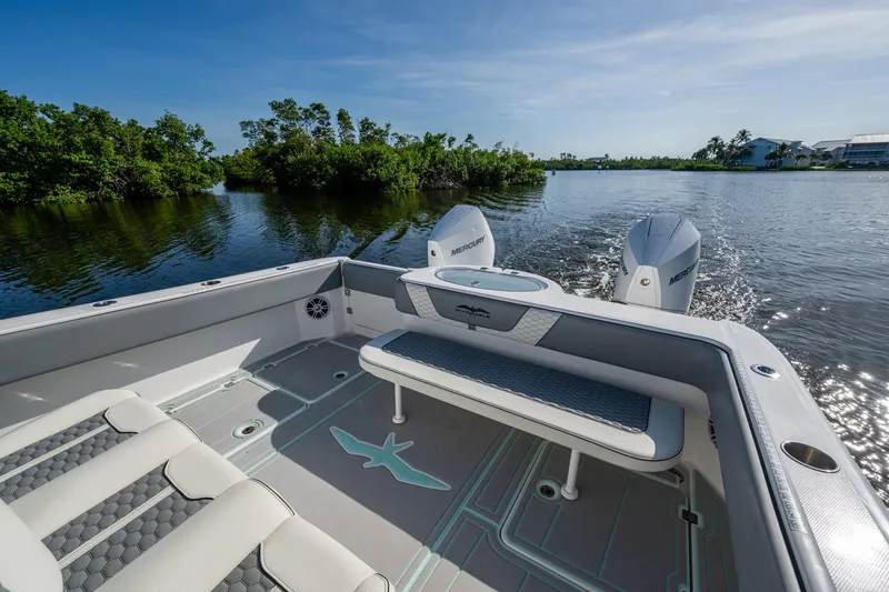 Slide: The Image of 2022 Invincible 33 Catamaran on calm water, featuring spacious seating and twin Mercury engines. - 26