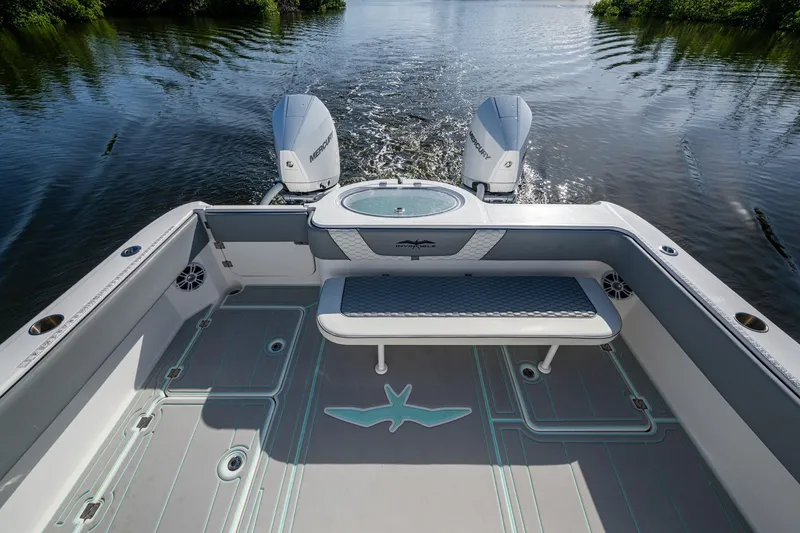 Slide: The Image of 2022 Invincible 33 Catamaran with twin Mercury engines on calm water. - 27