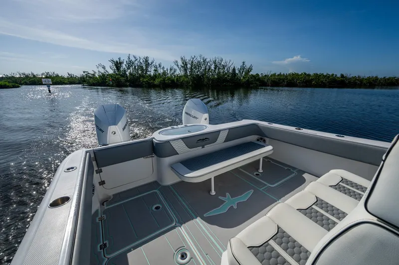 Slide: The Image of 2022 Invincible 33 Catamaran interior with seating, twin engines, and scenic water view. - 29