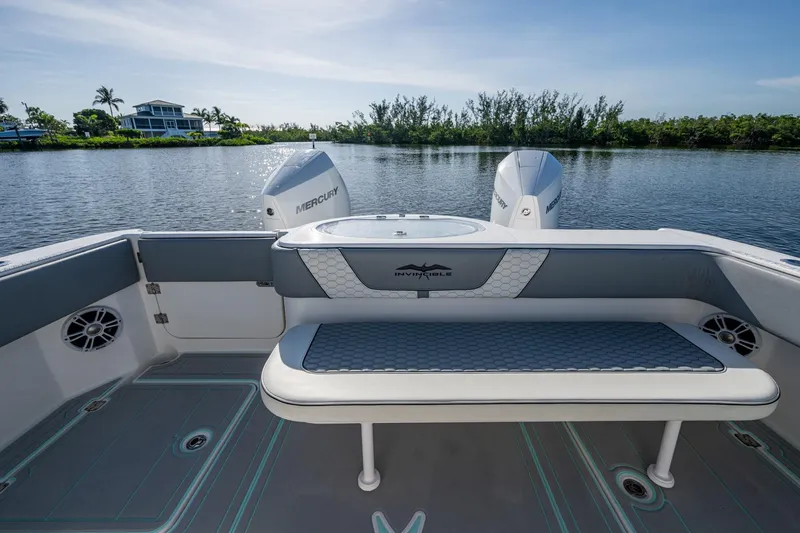 Slide: The Image of 2022 Invincible 33 Catamaran with Mercury engines, featuring a spacious deck and seating area. - 30