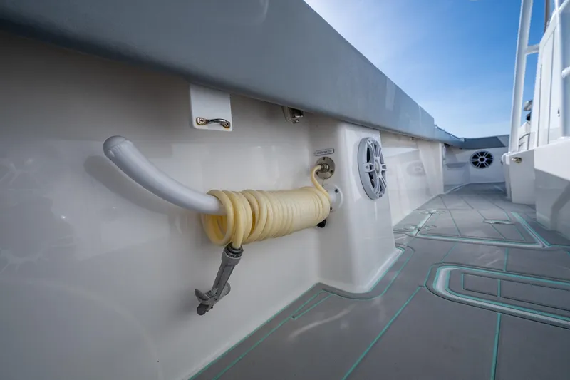 Slide: The Image of 2022 Invincible 33 Catamaran deck with coiled hose and speaker system. - 33