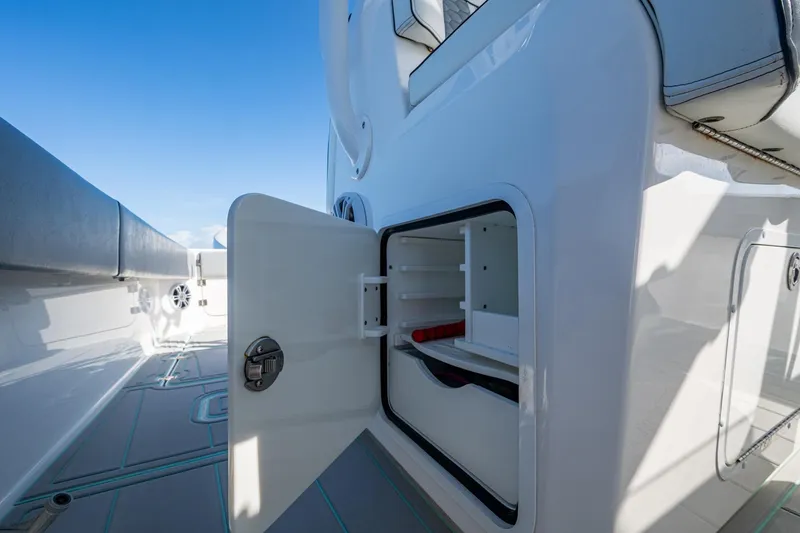 Slide: The Image of Open storage compartment on 2022 Invincible 33 Catamaran, showcasing sleek design and functionality. - 34