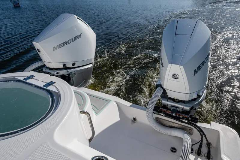 Slide: The Image of 2022 Invincible 33 Catamaran with dual Mercury outboard engines on water. - 36