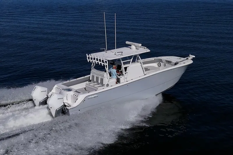 Slide: The Image of 2022 Invincible 33 Catamaran cruising on open water, showcasing sleek design and powerful engines. - 39