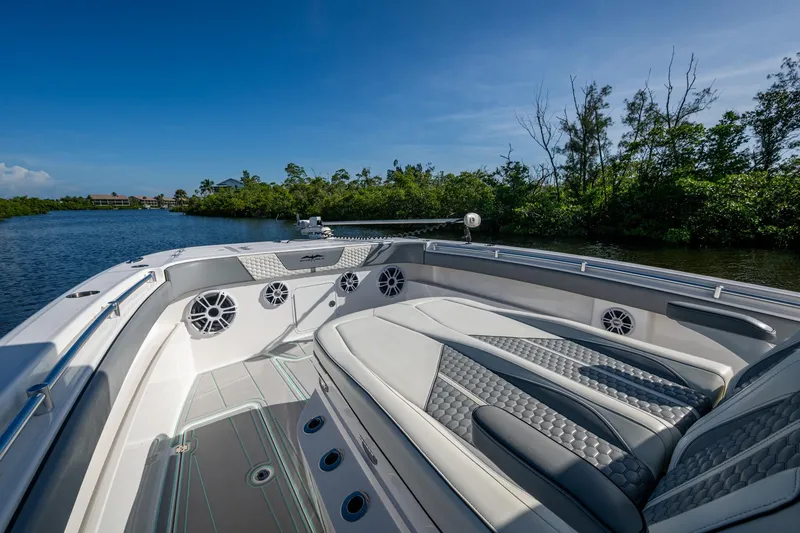 Slide: The Image of 2022 Invincible 33 Catamaran interior with luxurious seating and scenic waterway view. - 7