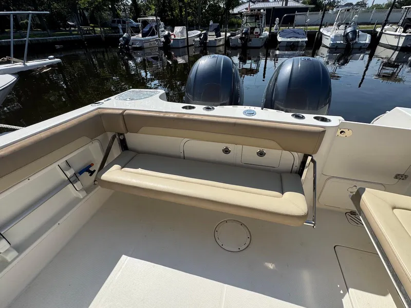 Slide: The Image of 2017 Sailfish 275 DC boat interior with seating and dual outboard motors. - 11