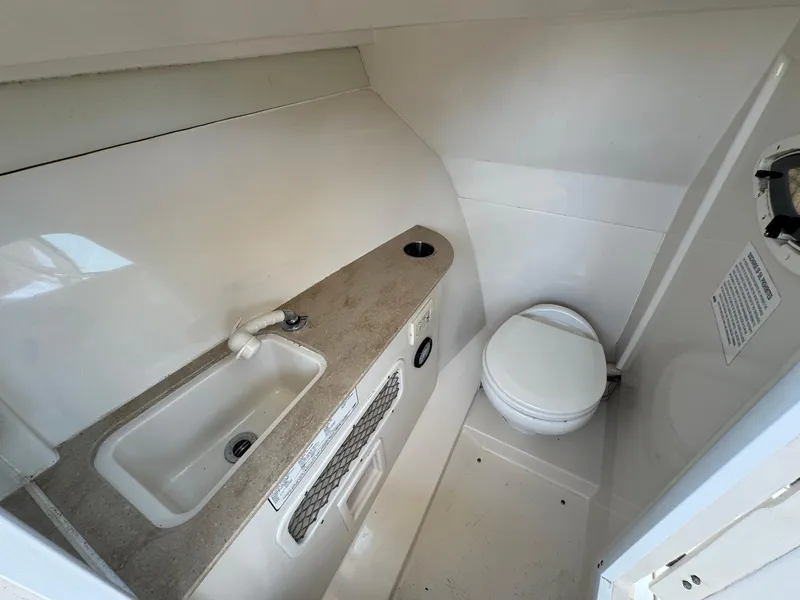Slide: The Image of 2017 Sailfish 275 DC boat interior with sink and toilet. - 18