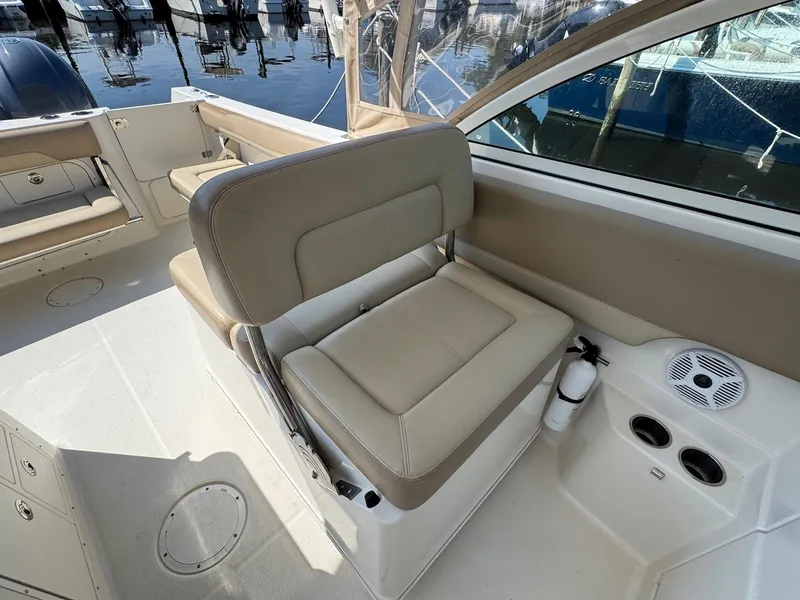 Slide: The Image of 2017 Sailfish 275 DC boat interior with beige seating and cup holders. - 6