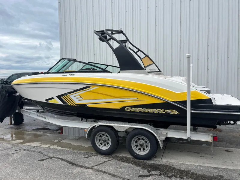 Slide: The Image of 2016 Chaparral Vortex 223 VRX boat with yellow accents on a trailer. - 1