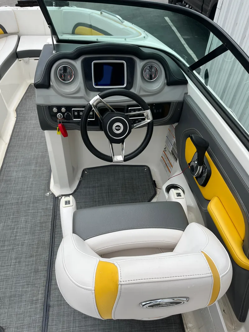 Slide: The Image of 2016 Chaparral Vortex 223 VRX boat cockpit with steering wheel and dashboard controls. - 12