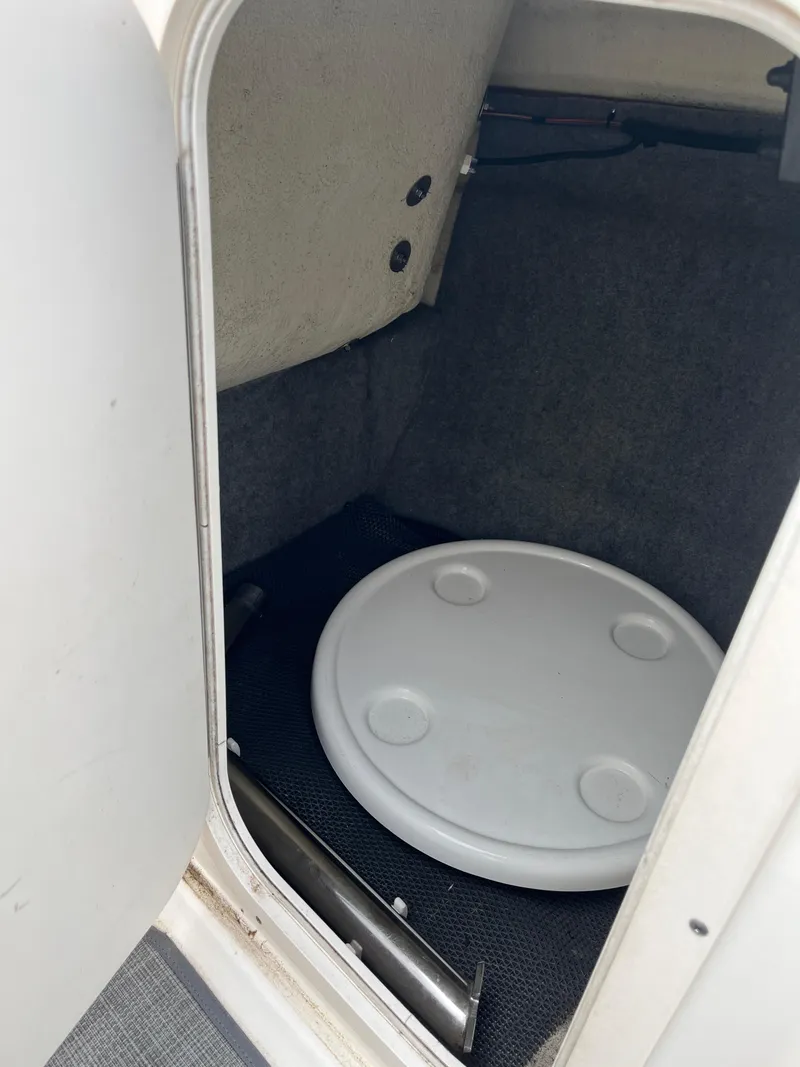 Slide: The Image of Storage compartment in 2016 Chaparral Vortex 223 VRX boat, featuring a round white lid. - 15