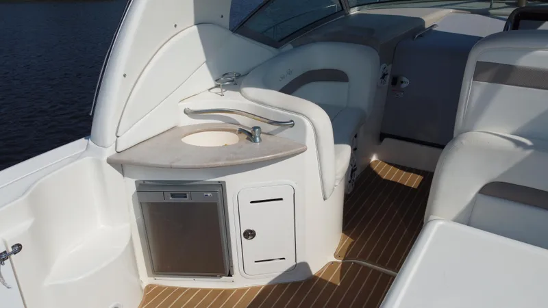 Slide: The Image of 2004 Sea Ray 320 Sundancer boat interior with sink and seating area. - 10