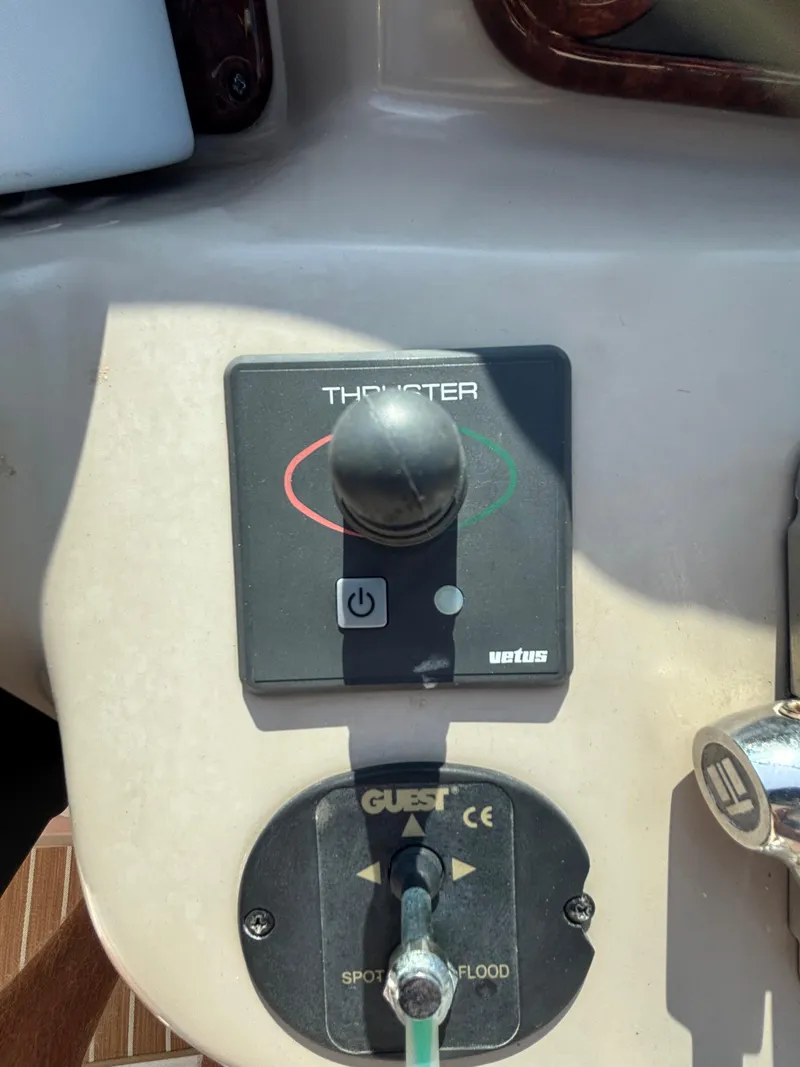 Slide: The Image of Control panel of a 2004 Sea Ray 320 Sundancer boat with thruster and spotlight controls. - 31